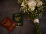 a pair of wedding books and a bunch of flowers on the wedding table