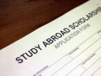 Someone filling out Study Abroad Scholarship Application Form.